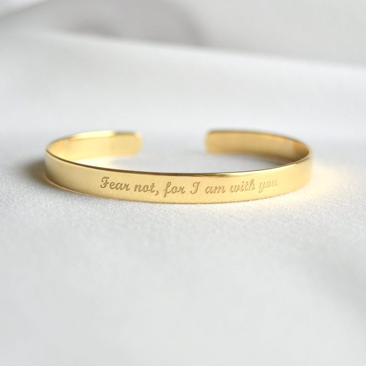 "Looking for a unique gift for a deeply religious person? Inspirational faith-based bracelet with message of faith, hope and love or uplifting words of encouragement will be a perfect gift. - Gold bracelet engraved with your chosen message. - The  thickness of gold plating is around 0.5 microns - Text, coordinates, numbers or handwriting outside and inside the cuff  - Up to 90 characters  on each side - Approximately 0.25 inch wide (6.3mm) - Laser engraved - the engraving is burned into the mate Engraved Gold Bracelet, 90 Characters, Faith Hope And Love, Gold Cuff Bracelet, God Christian, Wrist Jewelry, Uplifting Words, Gold Bracelet Cuff, Engraved Bracelet