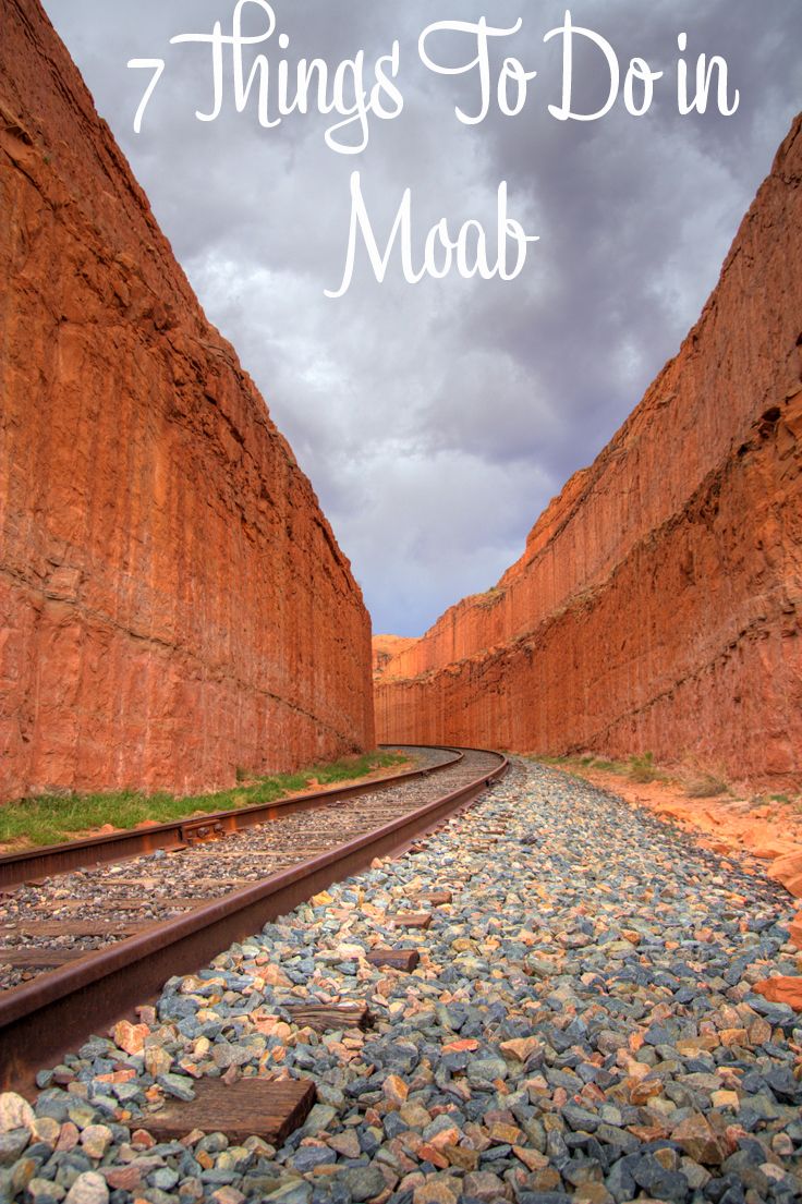 there is a train track in the middle of some rocks and grass on the ground