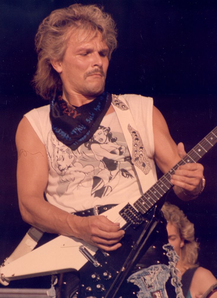 a man playing an electric guitar on stage