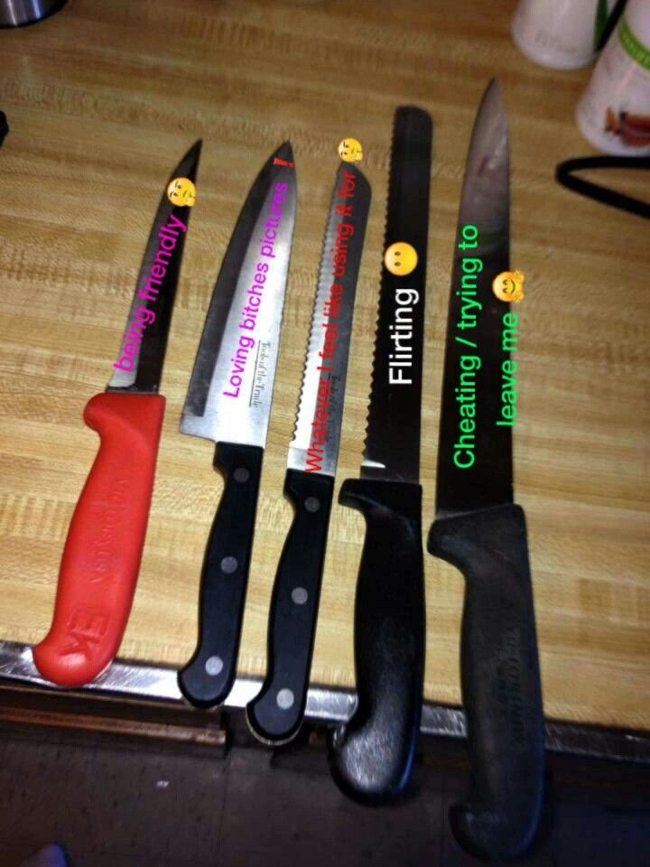 five knives are lined up on a table