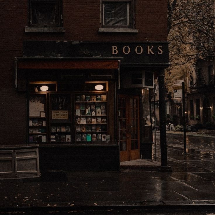 a book store sitting on the side of a street next to a tall brick building