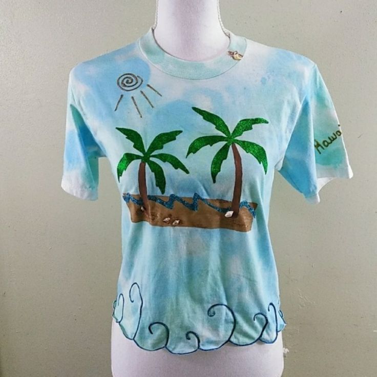 Hand Painted One-Of-A-Kind Tropical T-Shirt S When I Lived In Hawaii I Sold My One-Of-A-Kind T-Shirts At A Gift Shop In The King Kamehameha Hotel, And Recently Came Across A Few I Had Left. This One Measures Approx. 17" From Armpit To Armpit And Is About 19" In Length. I'd Recommend Hand Washing Because It's Decorated With Real Seashells. Note: Hand Painted; Imperfections Are A Part Of The Uniqueness Of The Top. Price Firm! A Lot Of Work Went Into This, And It's Already Discounted. Tie Dye Short Sleeve Vacation Top, Tie Dye Short Sleeve Top For Vacation, Blue Crew Neck Tops For Beach Season, Blue Short Sleeve T-shirt For Beach Season, Blue Short Sleeve T-shirt For Beach, Blue Short Sleeve Summer T-shirt, Light Blue Short Sleeve Tops For Beach Season, Light Blue Crew Neck Shirt For Summer, Tie Dye Short Sleeve Top For Beach