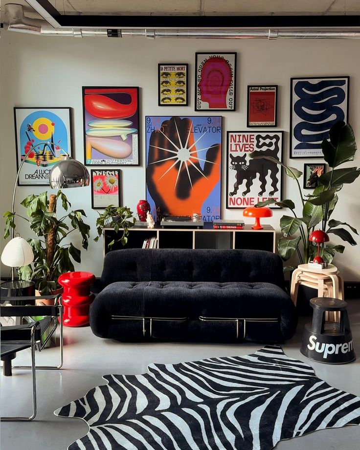 a living room filled with furniture and lots of pictures on the wall above it's couch