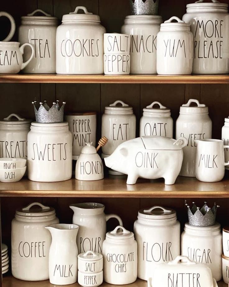 white kitchen canisters with words written on them