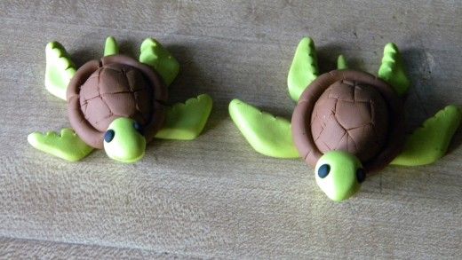 there are two small turtle figurines on the table