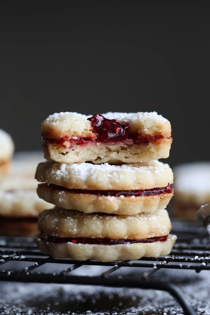 some cookies with jam are stacked on top of each other