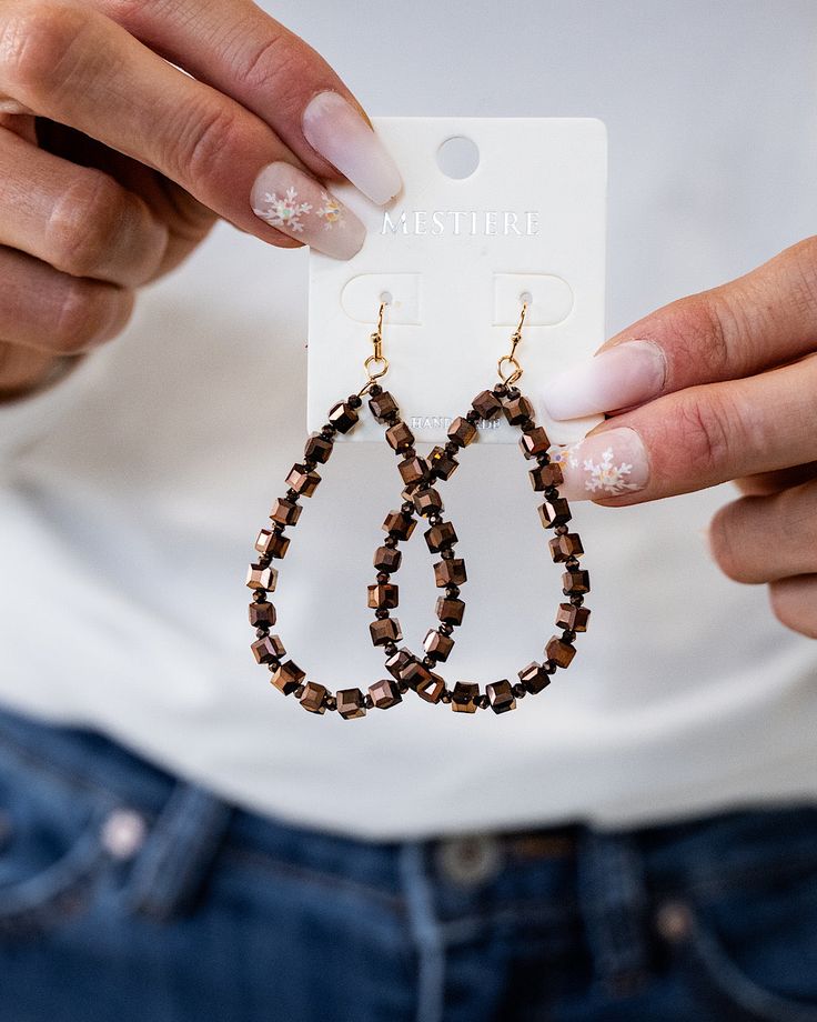 Tear drop earrings with alternating chocolate colored square and round beads Brown Metal Beaded Earrings With Ear Wire, Brown Faceted Beads Dangle Jewelry, Trendy Brown Teardrop Earrings, Brown Beaded Teardrop Jewelry, Brown Metal Beaded Drop Earrings, Elegant Teardrop Beaded Earrings In Brown, Elegant Brown Teardrop Beaded Earrings, Elegant Brown Metal Beaded Earrings, Brown Metal Beaded Dangle Earrings