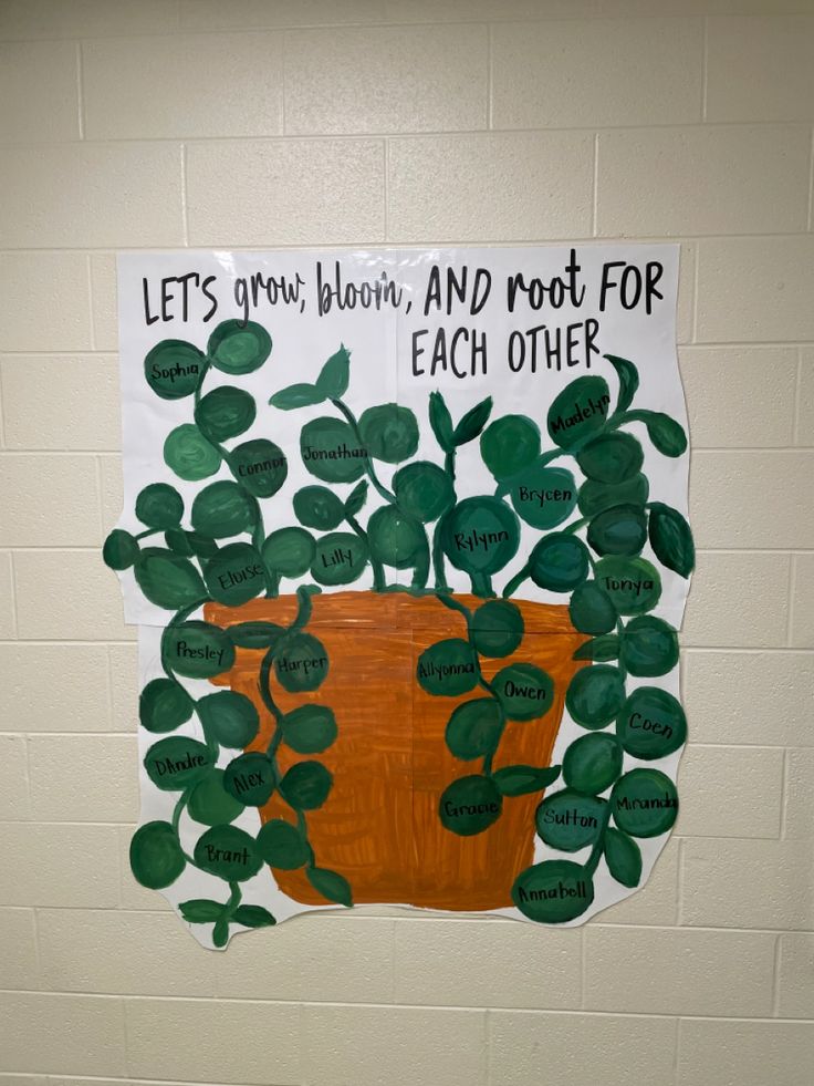 a bulletin board with a potted plant and words written on the wall in front of it