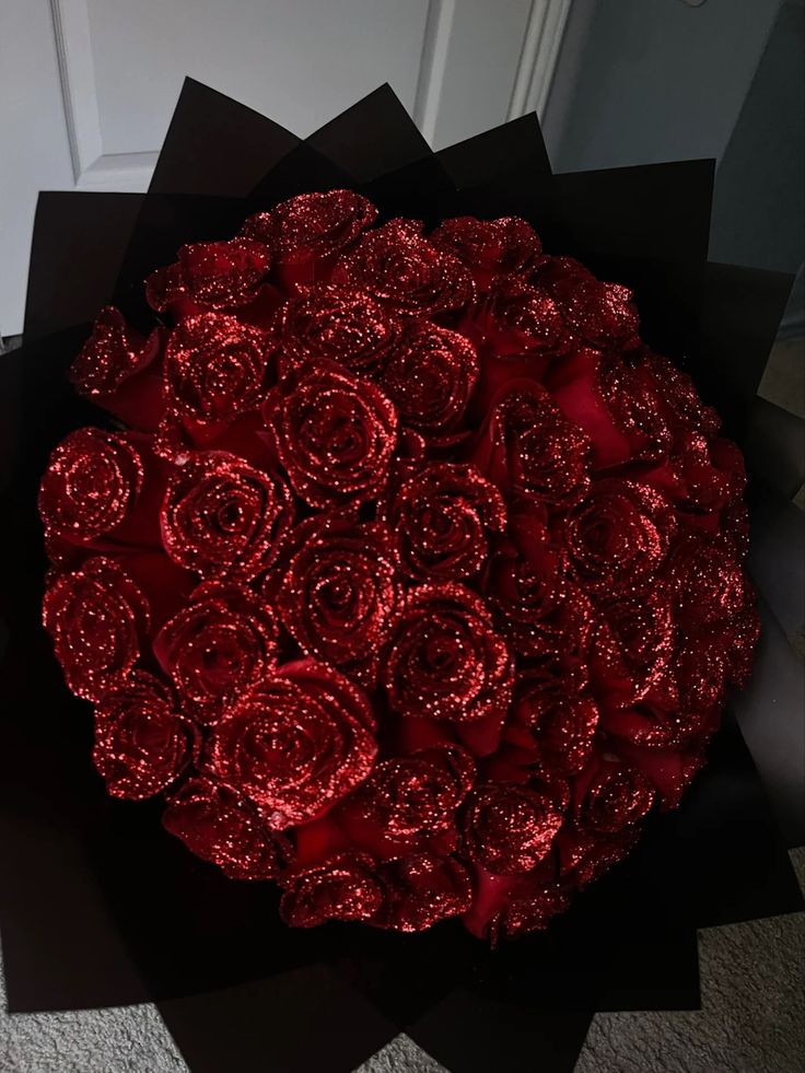 a large bouquet of red roses on the floor