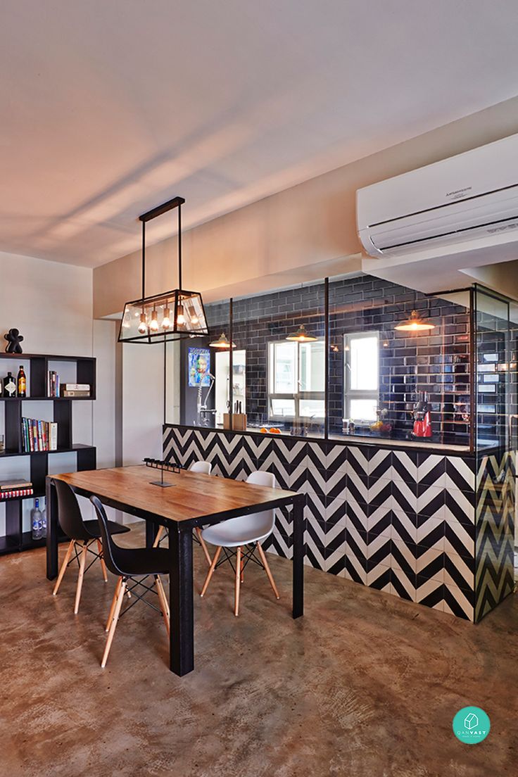 a dining room with black and white chevron tiles