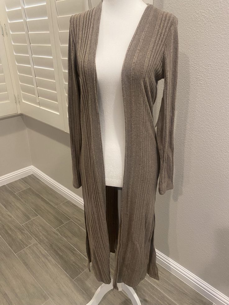 Casual long sleeve cardigan. 97% rayon 3% spandex Trendy Fitted V-neck Sweater Coat, Fitted Soft Knit V-neck Cardigan, Fitted Knit Cardigan For Layering, Fitted V-neck Soft Knit Cardigan, Elegant Soft Knit Long Sleeve Cardigan, Elegant Stretch Knit Cardigan, Brown Stretch Outerwear For Layering, Fitted V-neck Sweater Coat For Spring, Chic Brown Open Front Sweater