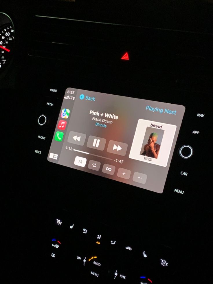 the dashboard of a car with an electronic device on it's display screen and steering wheel controls