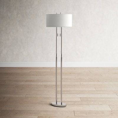 a floor lamp in an empty room with hard wood floors