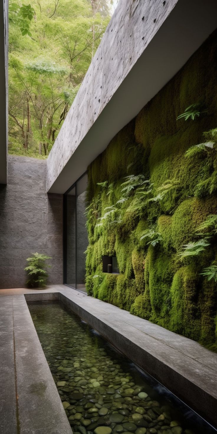 A modern and inviting garden design, featuring a stunning and lush moss wall, chic concrete features, and a serene small pond perfect for creating a unique and inspiring ambiance. Atrium Garden, Indoor Pond, Wall Concrete, Feature Wall Design, Small Pond, Indoor Waterfall, Vertical Garden Wall, Sunken Garden, Sea House