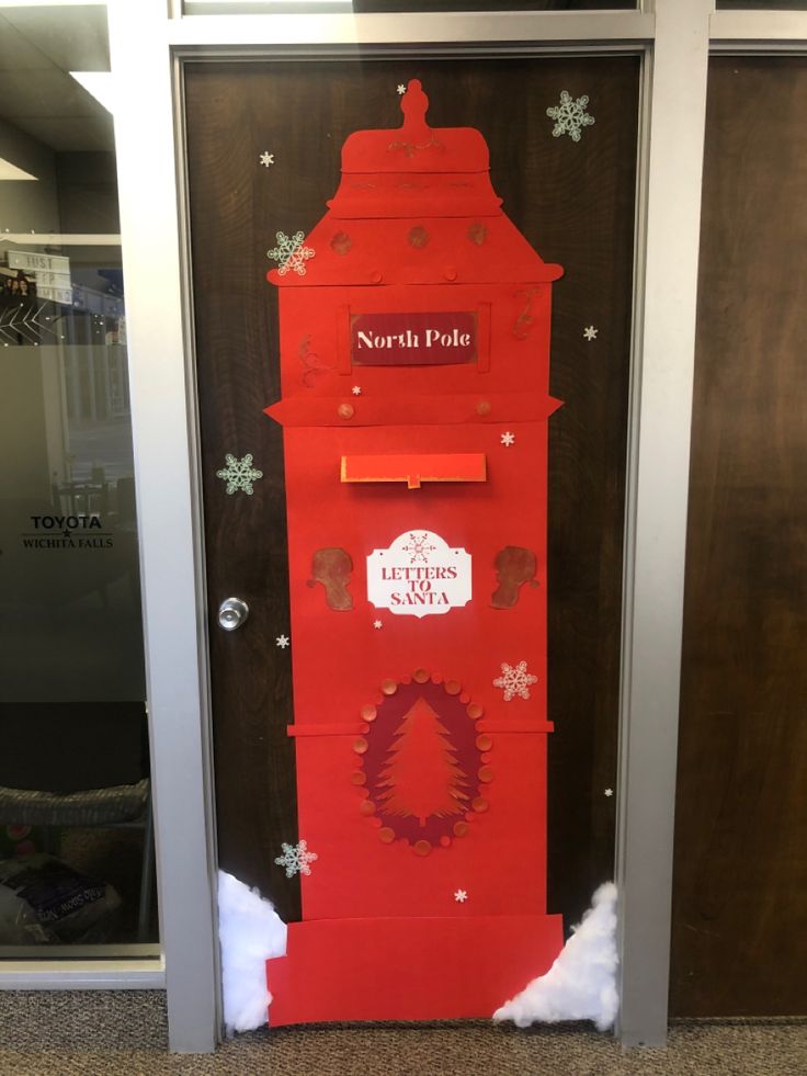 a red mailbox is decorated with snowflakes