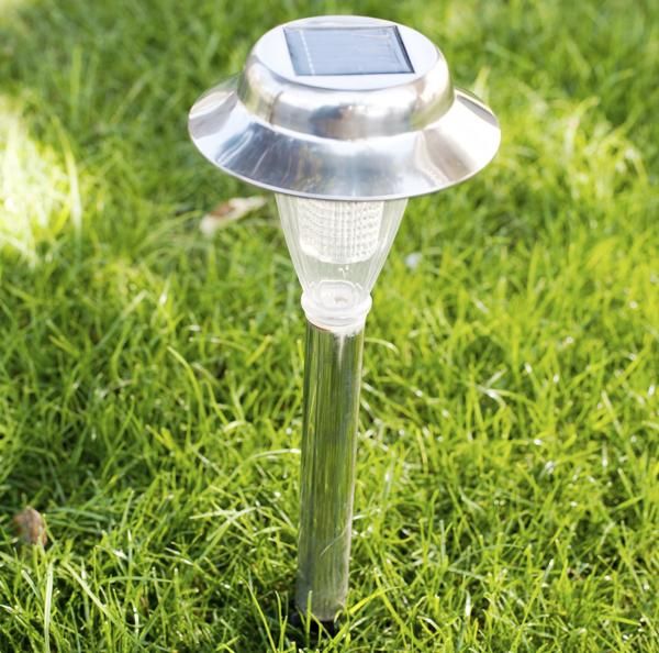 a solar powered lawn light in the grass