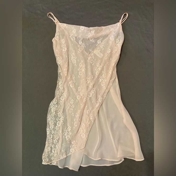 Pastel Peach Sheer Lace Nightgown/Slip In Size Large. Classically Feminine And Great Quality. Double Strapped With Tiny, Delicate Bows Where Straps Meet Gown. Straps Are Adjustable. It’s A Sheer Creamy Peach Gown With A Sheer Lace Wrapped Front In The Same Color. Has A Flattering Cowl Neckline. Bought And Never Worn. It Is In Great Condition. Sheer Fabric Is 100% Polyester While Lace Is 100% Nylon. It Is Machine Washable And Can Be Tumble Dried On Low. Please Feel Free To Message Me With Any Que Spring Night Sheer Slip Dress, Sheer Night Slip Dress For Spring, Sheer Lace Slip Dress For Sleep, Spring Sheer Nightgown For Sleep, Sheer Slip Dress For Spring Night, Pink Sheer Slip Dress For Summer, Spring Pink Lace Nightgown, Sheer Lace Sleepwear For Sleepover, Sheer Slip For Summer Sleepwear