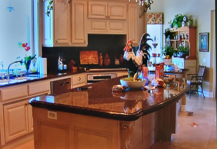 a large kitchen with an island in the middle and lots of counter space around it