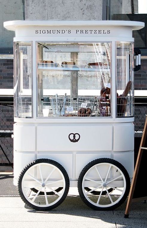 a white cart sitting on top of a sidewalk