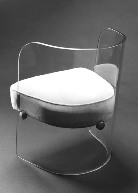 a chair with a white cushion on it's back and legs, sitting in front of a gray background