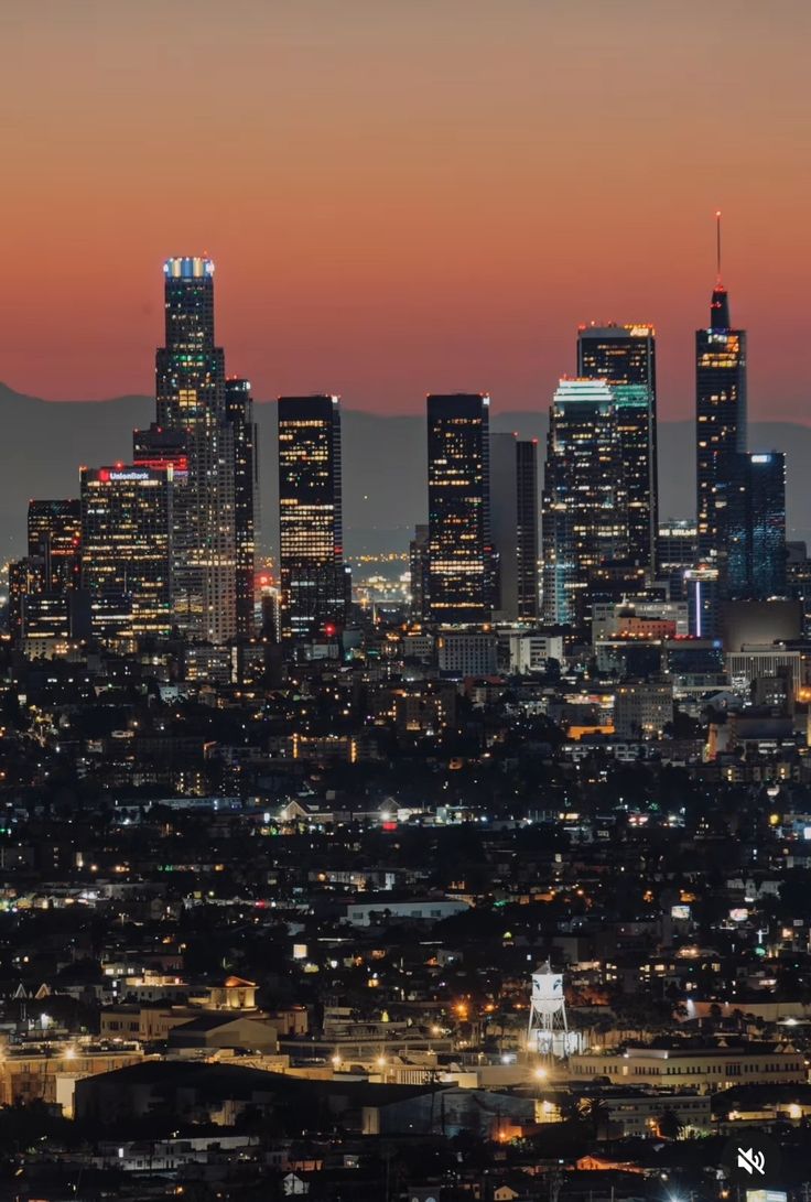 the city skyline is lit up at night