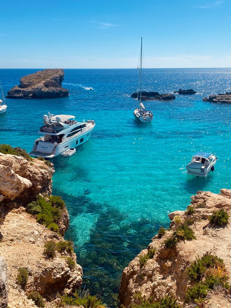 several boats floating in the clear blue water