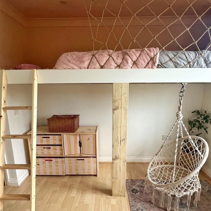 a room with a bed, chair and hammock hanging from the ceiling