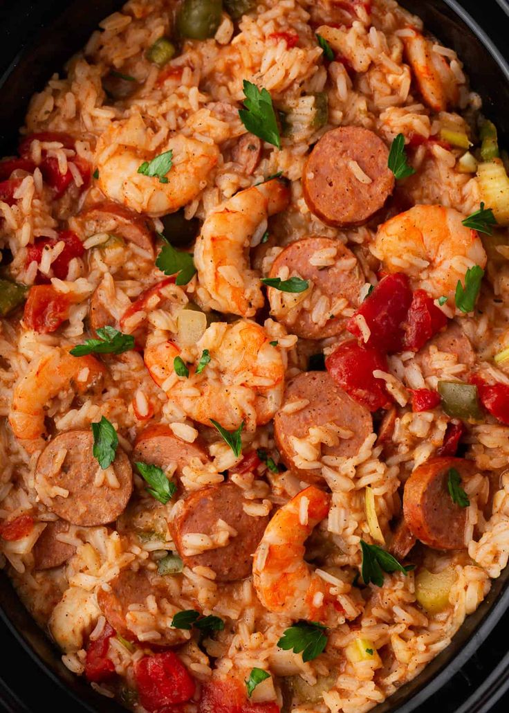 rice with sausage and vegetables in a crock pot, ready to be served for dinner