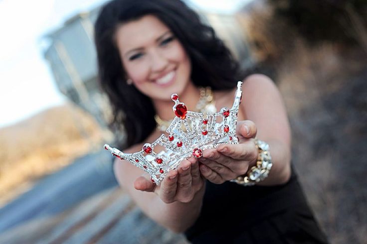 a woman holding a tiara in her hands