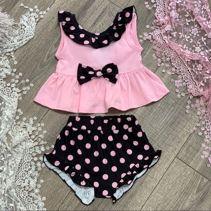 Baby Girls 3pc Pink And Black Polkadot And Ruffle Outfit Includes Ruffle Top, Ruffle Bummie Shorts And Matching Headband. Pink Minnie Mouse Sets For Spring, Spring Minnie Mouse Pink Sets, Spring Pink Minnie Mouse Sets, Cute Polka Dot Cotton Set, Cute Polka Dot Summer Sets, Cute Polka-dotted Cotton Set, Playful Minnie Mouse Summer Set, Summer Cotton Minnie Mouse Sets, Minnie Mouse Cotton Summer Sets