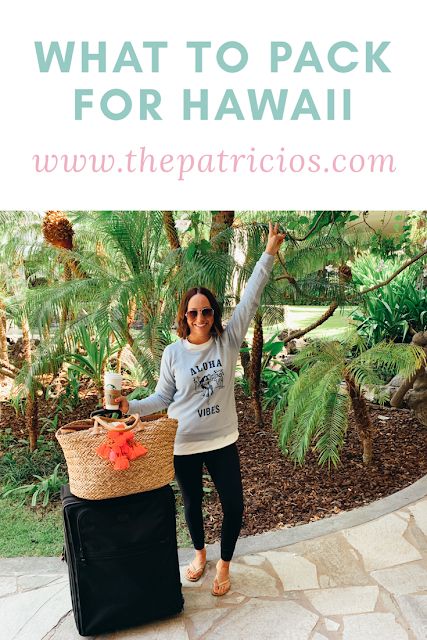 a woman standing in front of a palm tree with her luggage