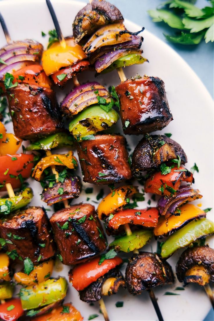 skewered meat and vegetables on a white plate