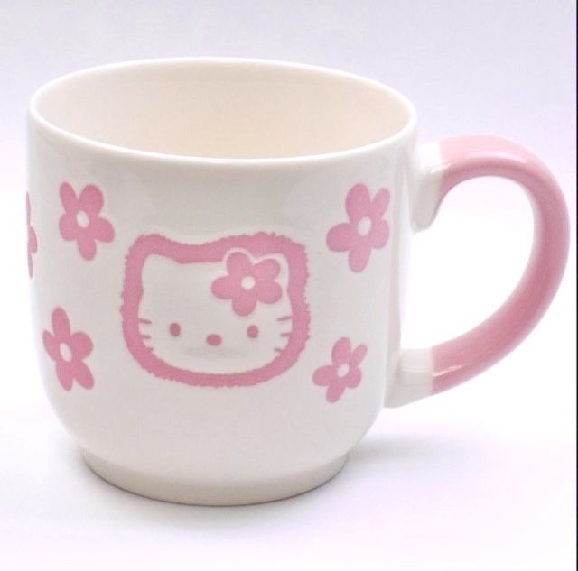 a hello kitty coffee cup with pink flowers on it