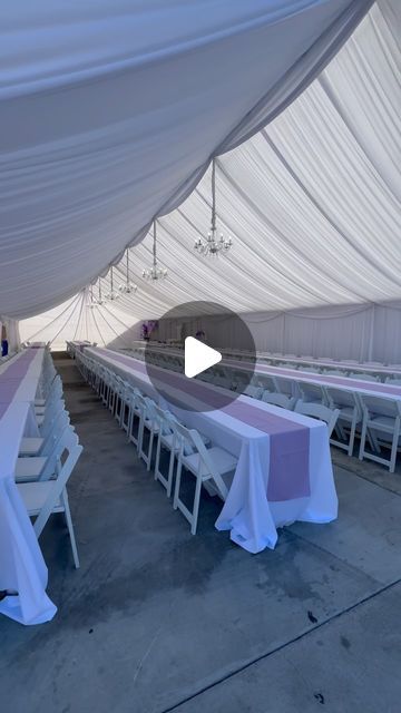 a large white tent with tables and chairs