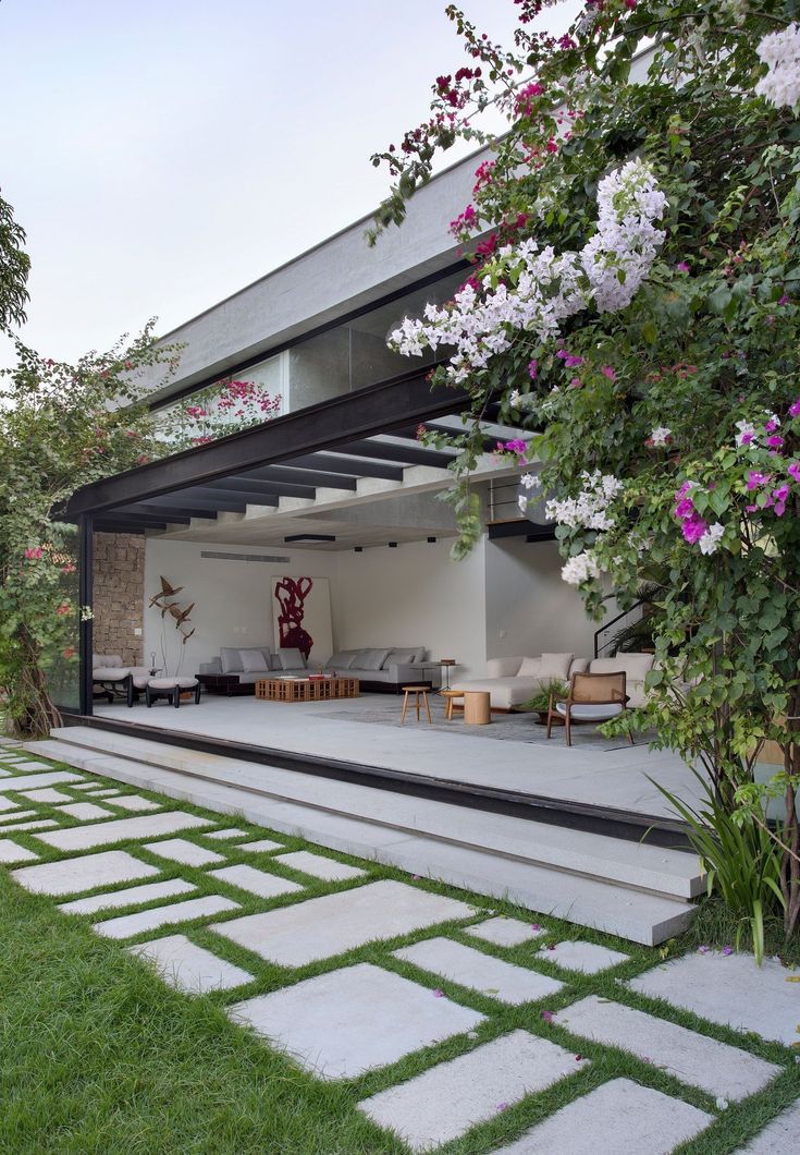 an outdoor living area with stone steps and grass