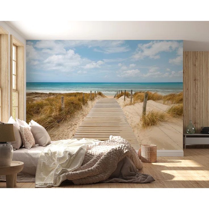 a bedroom with a wooden walkway leading to the beach wallpapered in beige and blue