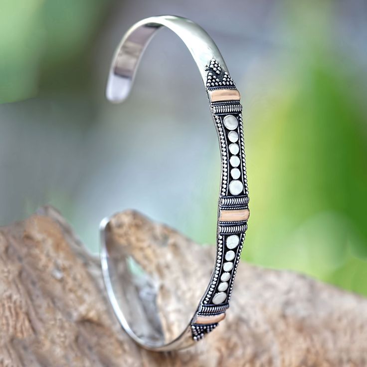 This slender cuff bracelet is adorned with the traditional art motifs of Bali. By Sukartini, its sterling silver surface features accents bathed in 18k gold. 18k gold plated sterling silver Handmade in Indonesia Unique Sterling Silver Jewelry, Plain Silver Rings, Sterling Silver Bangle Bracelets, Elegant Bracelet, Sterling Silver Cuff Bracelet, Moon Jewelry, Silver Bangle Bracelets, Sterling Silver Bangles, Gold Accent