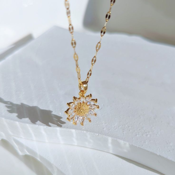 Our genuine, high-quality Sunflower Necklace is a unique statement piece that will make any outfit look more elegant. This elegant floral necklace is made of real stainless steel dipped in 18k gold and accented with cubic zirconia crystals. It’s hypoallergenic, water resistant and handcrafted in California. ✔Hypoallergenic ✔Quality Guaranteed ✔Water Resistant ✔Handmade MATERIAL: stainless steel dipped in real 18k gold COLOR: gold, cubic zirconia crystals LENGTH: 18 inches Hip Jewelry, Purple Pendant Necklace, Purple Pendant, Sunflower Necklace, Daisy Necklace, The Sunflower, Jewelry Essentials, Girl Friend, Pretty Stuff