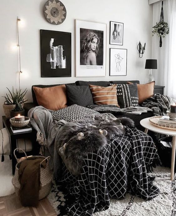 a black and white living room with pictures on the wall, rugs and furniture