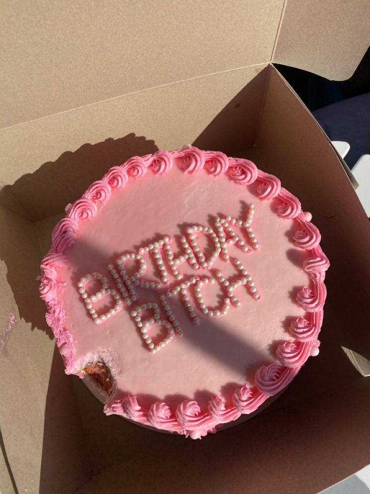 a pink birthday cake with the words happy birthday written on it