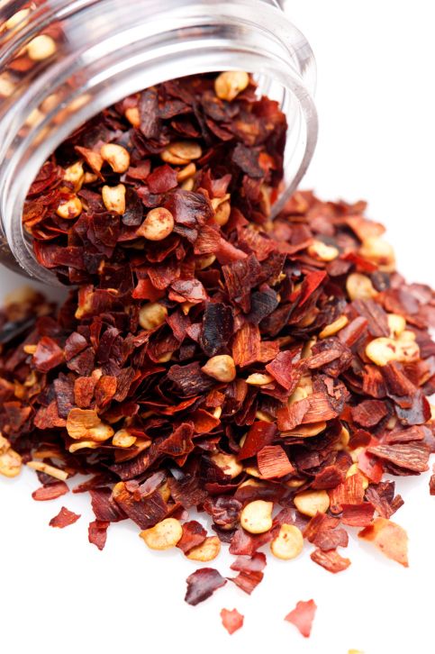 a glass jar filled with dried red flowers