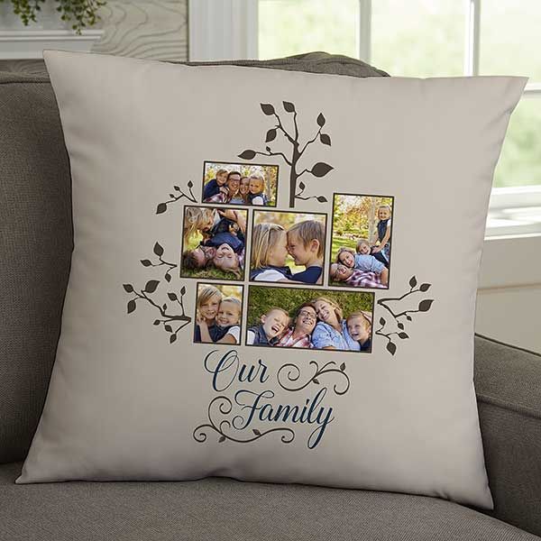 a family photo pillow on a couch with the words our family written in blue ink