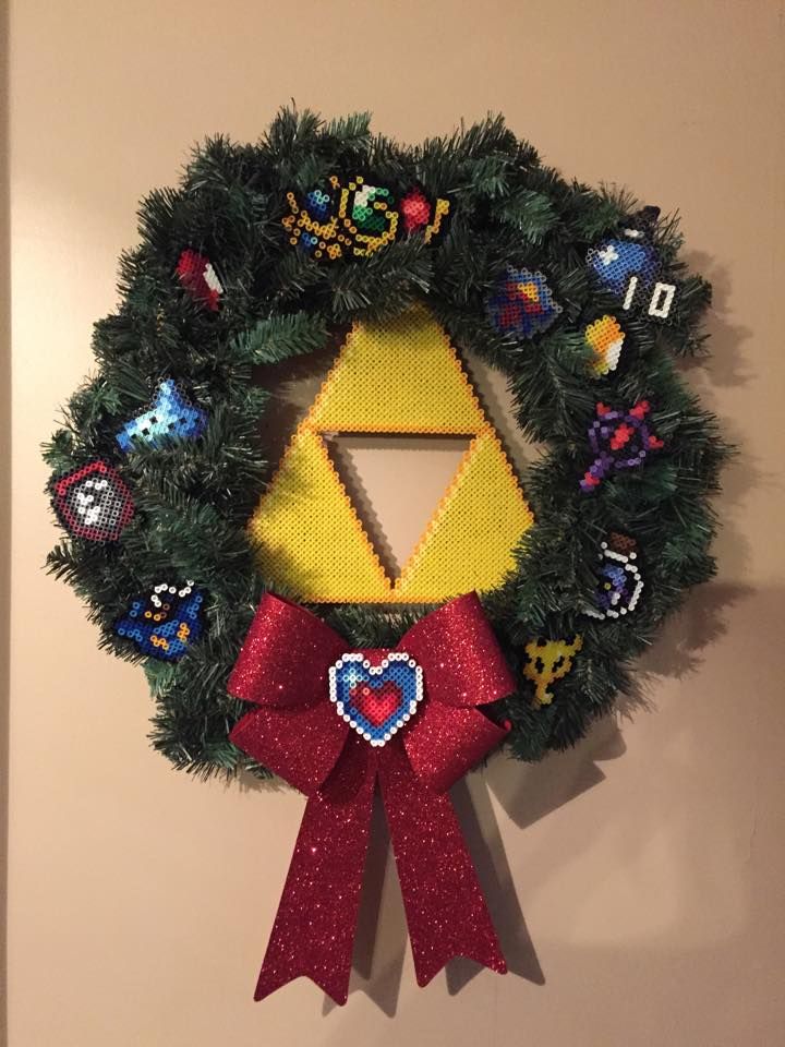 a decorated wreath hanging on the wall next to a nintendo wii controller and other items