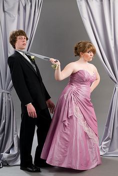 a young man and woman dressed in formal wear standing next to each other with swords