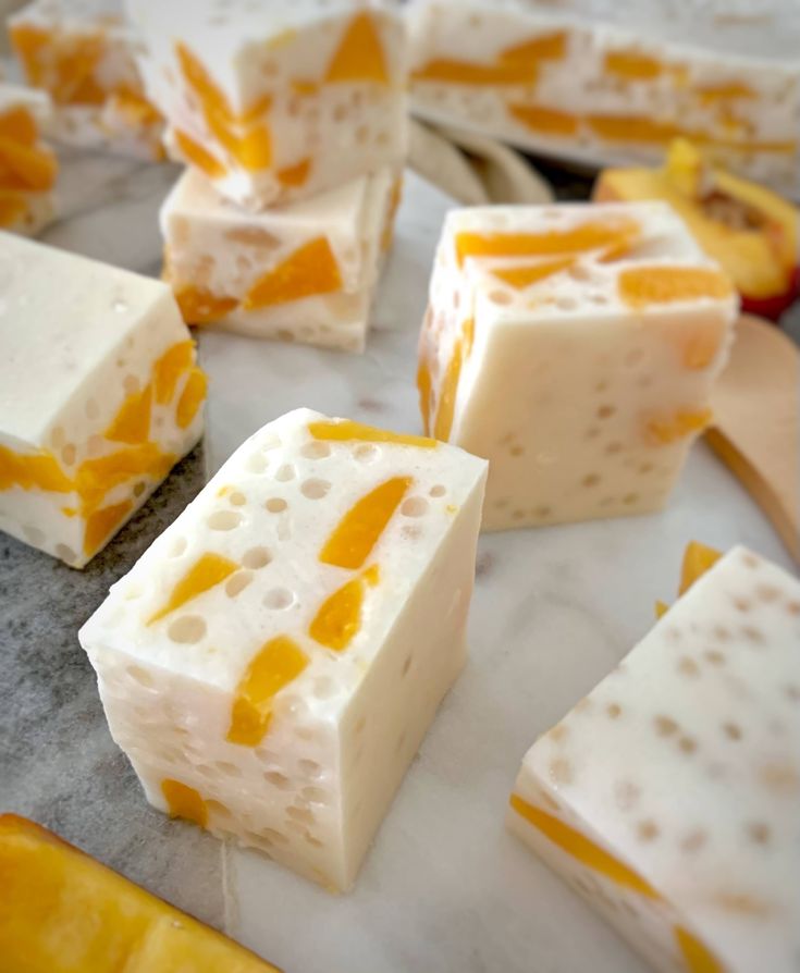 several pieces of cheese sitting on top of a counter