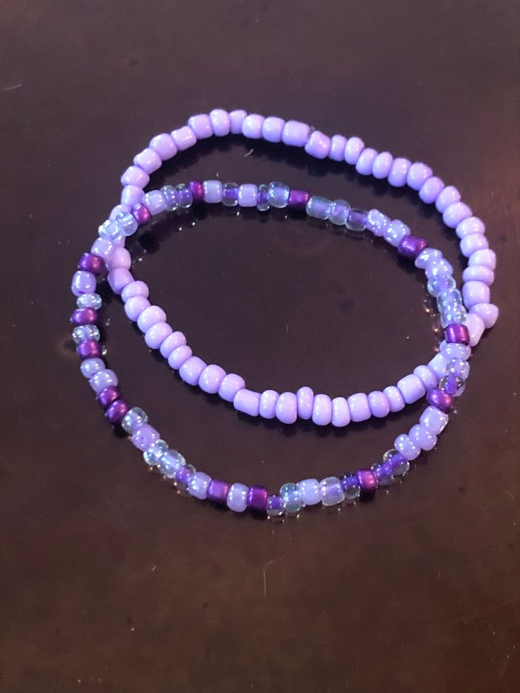 These handmade purple bracelets are just full of bright color!  Either one is sure to please any purple lover like myself!  Whether you decide on the light purple, shades of purple, or stack them both, I'm sure they will look gorgeous on you!  Very nice, bright colors. They compliment each other well.  Simple, but still adds color to any outfit! Adults and kids sizes available! Adjustable Lavender Bracelets For Beach, Bohemian Purple Stretch Bracelet With Round Beads, Purple Bracelet Jewelry For The Beach, Purple Bracelet Jewelry For Beach, Handmade Purple Stretch Bracelet For Beach, Handmade Adjustable Purple Bracelets, Handmade Adjustable Purple Bracelet, Handmade Purple Bohemian Stretch Bracelet, Handmade Lavender Stretch Bracelet With Round Beads