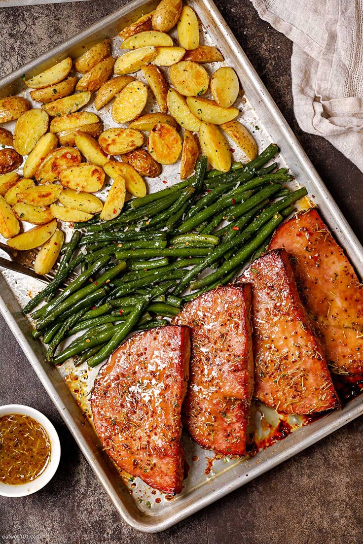 a pan filled with fish, potatoes and green beans