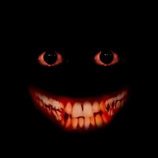 an evil looking face in the dark with blood on it's mouth and teeth