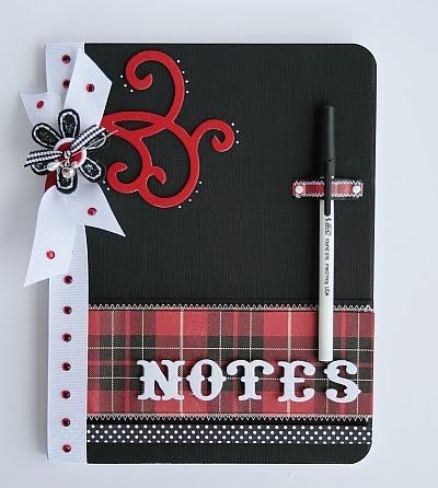 a note book with a pen on top of it and the word notes written in white