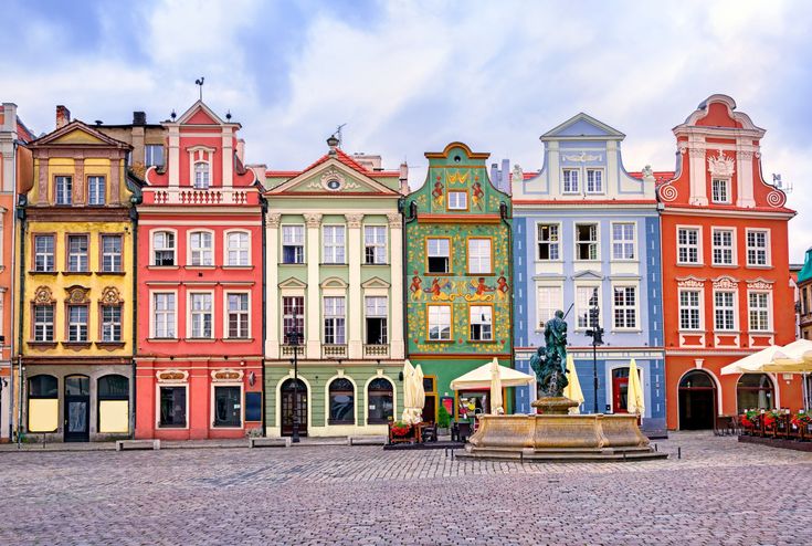 many colorful buildings with a fountain in the middle